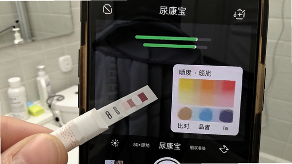 尿康宝app试纸识别操作界面,手机摄像头对准尿液试纸,屏幕显示识别进度与比色结果,居家卫生间场景,明亮清晰,医疗健康风格