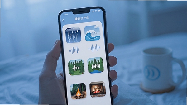 睡眠白噪音软件界面展示,手机屏幕显示多种自然音效图标,雨声海浪森林篝火等,简约清新风格,助眠放松场景,蓝色调为主